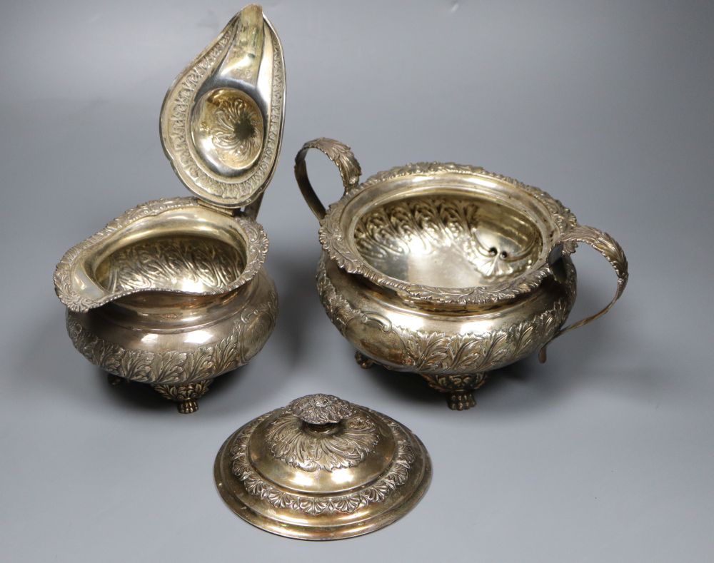 A George IV embossed silver lidded sugar bowl and matching cream jug, Joseph Angell I, London, 1823, 34.5oz.